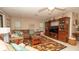 Spacious living room with an entertainment center, sectional sofa, and colorful rug enhancing its appeal at 6620 Brambleleaf Dr, Spring Hill, FL 34606