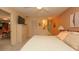 Relaxing bedroom with a closet, adjacent bathroom, and views into the dining room at 6620 Brambleleaf Dr, Spring Hill, FL 34606