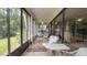 Enclosed patio with tile flooring, ceiling fan, wicker seating, and views of the backyard at 6620 Brambleleaf Dr, Spring Hill, FL 34606