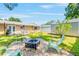 Serene backyard featuring a fire pit area, perfect for outdoor entertaining and relaxation at 6656 Pinecrest N Ln, Pinellas Park, FL 33781