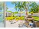 Outdoor cooking and dining area with a grill, set in a spacious backyard with a shed at 6656 Pinecrest N Ln, Pinellas Park, FL 33781