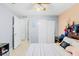 Bedroom with a large bed, view into closet and lots of light at 6656 Pinecrest N Ln, Pinellas Park, FL 33781