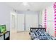 Bright bedroom with a ceiling fan, closet, and fun baseball themed decor at 6656 Pinecrest N Ln, Pinellas Park, FL 33781