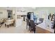 Well-lit dining area featuring a modern table set and an open view into the kitchen at 6656 Pinecrest N Ln, Pinellas Park, FL 33781
