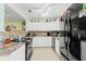 Bright kitchen with white cabinets, stainless steel appliances and granite countertops at 6656 Pinecrest N Ln, Pinellas Park, FL 33781