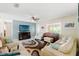 Cozy living room with a ceiling fan, comfortable seating, and a TV for relaxation and entertainment at 6656 Pinecrest N Ln, Pinellas Park, FL 33781