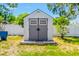 Durable backyard shed with double doors providing extra storage space for tools and equipment at 6656 Pinecrest N Ln, Pinellas Park, FL 33781