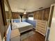 Comfortable bedroom featuring wood-look walls, a queen-sized bed, and ample dresser space at 7104 Fair Ln, Hudson, FL 34667