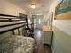 View of bunk bed room with desk, dresser and view to the entryway at 7104 Fair Ln, Hudson, FL 34667