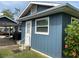 Side view of a cozy home featuring a new door, window, and vibrant landscaping for a welcoming aesthetic at 7104 Fair Ln, Hudson, FL 34667