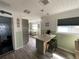 Bright kitchen featuring a breakfast bar with seating, light-green walls, and updated appliances at 7104 Fair Ln, Hudson, FL 34667