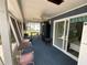Enclosed lanai with furnishings, offering a relaxing space for outdoor living and dining at 7104 Fair Ln, Hudson, FL 34667