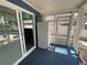 Enclosed lanai with refrigerator and sliding doors, perfect for entertaining and enjoying the views at 7104 Fair Ln, Hudson, FL 34667