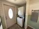Convenient laundry area by the door features a stacked washer and dryer maximizing space at 7104 Fair Ln, Hudson, FL 34667