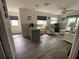 Open-concept living area with light wood-look floors and direct access to the front entry at 7104 Fair Ln, Hudson, FL 34667