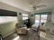 Cozy living room featuring wood-look tile flooring, plenty of natural light, and coastal decorations at 7104 Fair Ln, Hudson, FL 34667