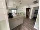 View from the kitchen looking into the living room with a sliding door to the back patio and waterfront at 7104 Fair Ln, Hudson, FL 34667