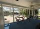 Enclosed porch with waterfront views and outdoor seating area, ideal for relaxation and enjoying the scenery at 7104 Fair Ln, Hudson, FL 34667