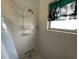 Shower featuring a convenient caddy and natural light, enhancing the bathing experience at 7104 Fair Ln, Hudson, FL 34667