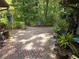 Paver patio surrounded by lush landscaping, creating a serene outdoor retreat at 7323 Ray Browning Rd, Brooksville, FL 34601