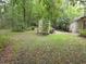 A sprawling backyard with a shed, trees, and lush grass creates a picturesque outdoor space at 7323 Ray Browning Rd, Brooksville, FL 34601