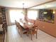Spacious dining room with a large table, seating for ten, and a decorative light fixture at 7323 Ray Browning Rd, Brooksville, FL 34601