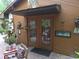 Entrance to a wooden home with many outdoor decorations and a brick walkway at 7323 Ray Browning Rd, Brooksville, FL 34601