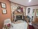 Living room fireplace with stone surround, mantle decorations, and dining table to the side at 7323 Ray Browning Rd, Brooksville, FL 34601