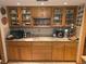 Kitchen featuring granite countertops, a tiled backsplash, and lots of wood cabinets at 7323 Ray Browning Rd, Brooksville, FL 34601