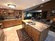 Spacious kitchen featuring granite countertops, a central island with sink, and wood cabinets at 7323 Ray Browning Rd, Brooksville, FL 34601