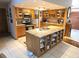 Bright kitchen featuring a functional island with storage, modern appliances, and ample cabinet space at 7323 Ray Browning Rd, Brooksville, FL 34601