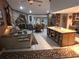 Open-concept living room featuring a stone fireplace, dining area, and kitchen with center island at 7323 Ray Browning Rd, Brooksville, FL 34601