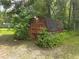 Outbuilding surrounded by trees, shrubs and natural landscaping at 7323 Ray Browning Rd, Brooksville, FL 34601