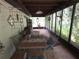 Charming sunroom with tile flooring, casual seating, and natural light at 7323 Ray Browning Rd, Brooksville, FL 34601