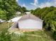 Aerial view of the home's rear exterior with a covered patio and well-kept lawn at 7353 Thorpp Ave, Brooksville, FL 34613