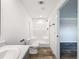 Bright bathroom featuring a shower, toilet, sink and wood-look flooring at 7353 Thorpp Ave, Brooksville, FL 34613