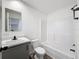 Bright bathroom with white fixtures and gray vanity at 7353 Thorpp Ave, Brooksville, FL 34613