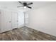 Comfortable bedroom featuring wood-look flooring, ceiling fan, and natural light from the window at 7353 Thorpp Ave, Brooksville, FL 34613