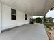 Large carport area with concrete flooring provides covered parking and access at 7353 Thorpp Ave, Brooksville, FL 34613