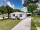 Charming single-story home with a well-maintained lawn and long driveway at 7353 Thorpp Ave, Brooksville, FL 34613
