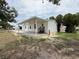 A single-story home's rear exterior, featuring a spacious covered patio and entrance at 7353 Thorpp Ave, Brooksville, FL 34613