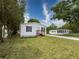 Well-maintained single-story home with a quaint porch and a lush green lawn at 7353 Thorpp Ave, Brooksville, FL 34613