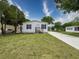 Cozy home with a well-manicured lawn, complemented by landscaped accents and a paved driveway at 7353 Thorpp Ave, Brooksville, FL 34613