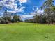 Golf course featuring lush green grass and trees under a bright sky at 7353 Thorpp Ave, Brooksville, FL 34613