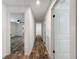 A bright hallway with wood-look floors and white walls at 7353 Thorpp Ave, Brooksville, FL 34613