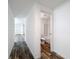 Hallway with wood-look floors leading to a bathroom at 7353 Thorpp Ave, Brooksville, FL 34613