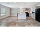 Modern kitchen with an island, pendant lighting, stainless steel appliances, and grey cabinetry at 7353 Thorpp Ave, Brooksville, FL 34613