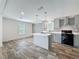 A modern kitchen with gray cabinetry, stainless steel appliances, and wood-look flooring at 7353 Thorpp Ave, Brooksville, FL 34613