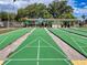 Community shuffleboard courts surrounded by trees, ideal for outdoor activities at 7353 Thorpp Ave, Brooksville, FL 34613