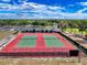 Overhead view of the community tennis courts with manicured landscaping and parking at 7353 Thorpp Ave, Brooksville, FL 34613